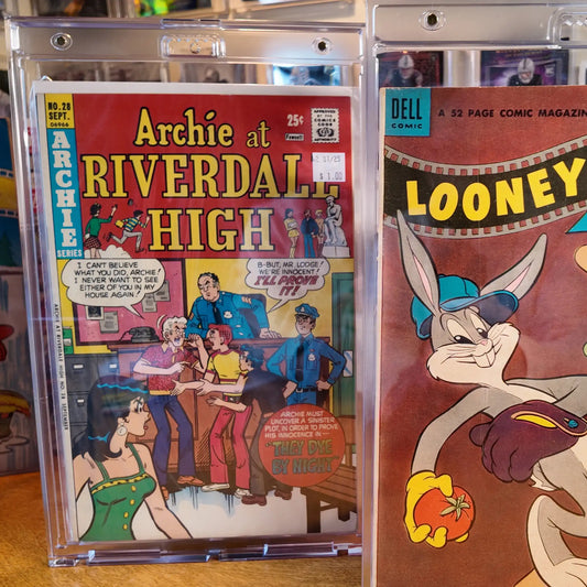 Two vintage comic books displayed in FlexDeez OneTouch wall-mounted 